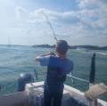 BoyFishingOffBackOfBoat